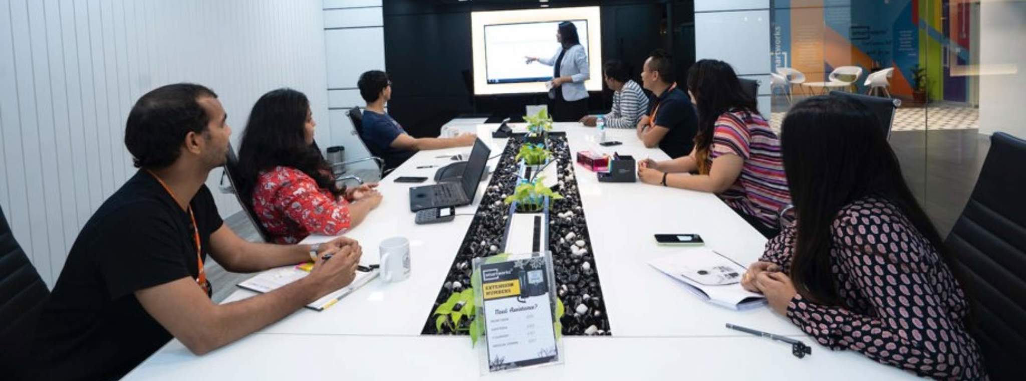 A group of people in a room being presented to