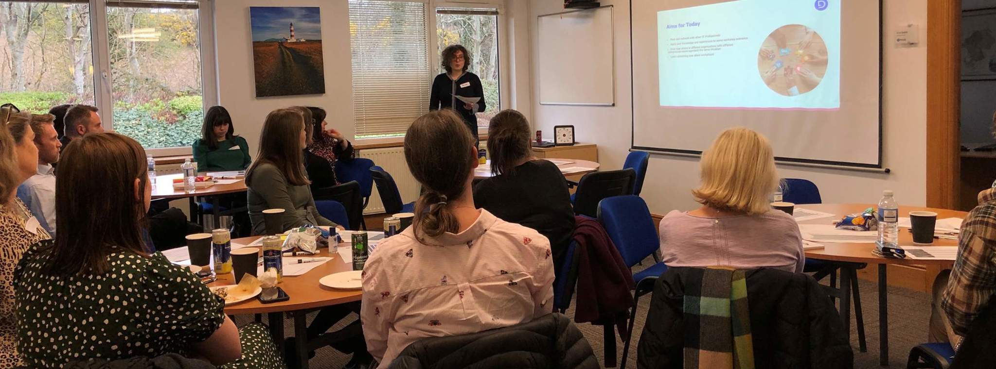Picture showing Alexandra Koyfman presenting to group of attendees