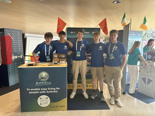 A photo of the ArthEsy team posing for a photo in front of their trade stand