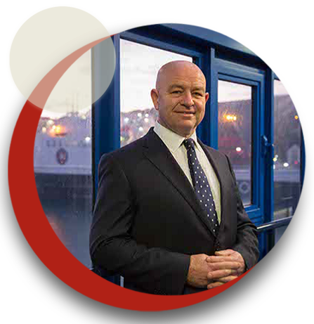 Circular image of Duncan jude smiling with steampacket vessel visable in the background