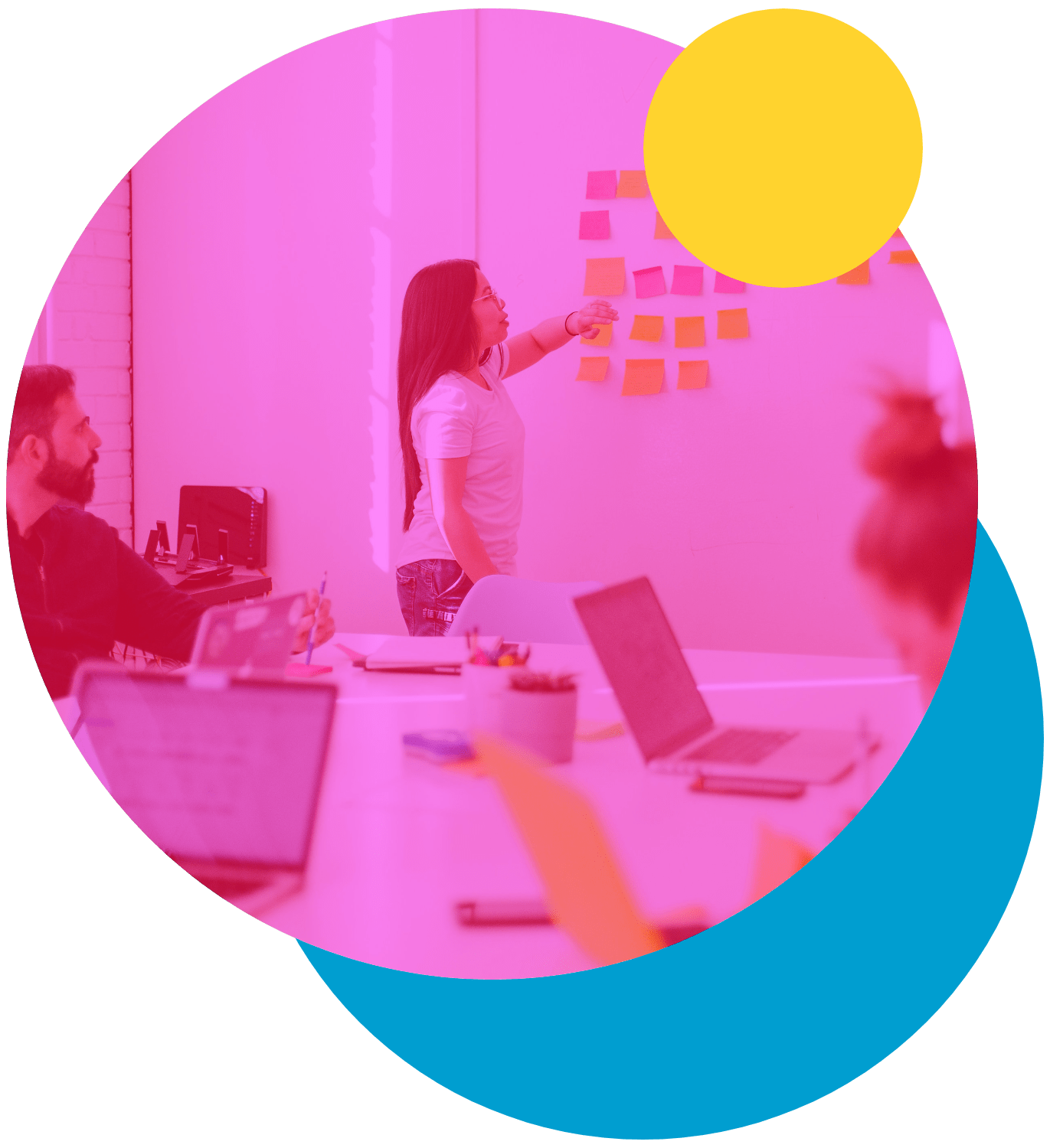 an image taken from the perspective of someone sat at a desk in a meeting looking forward to a woman placing post it notes on the wall