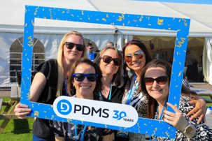A group of five woman posing in a PDMS 30 years frame