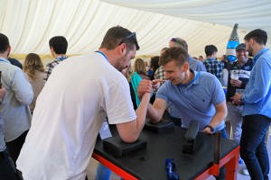Two men taking part in arm wrestling competition at PDMS Fest