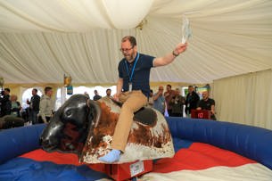 Robert Gassmann riding the mechanical bull at the PDMS Fest party
