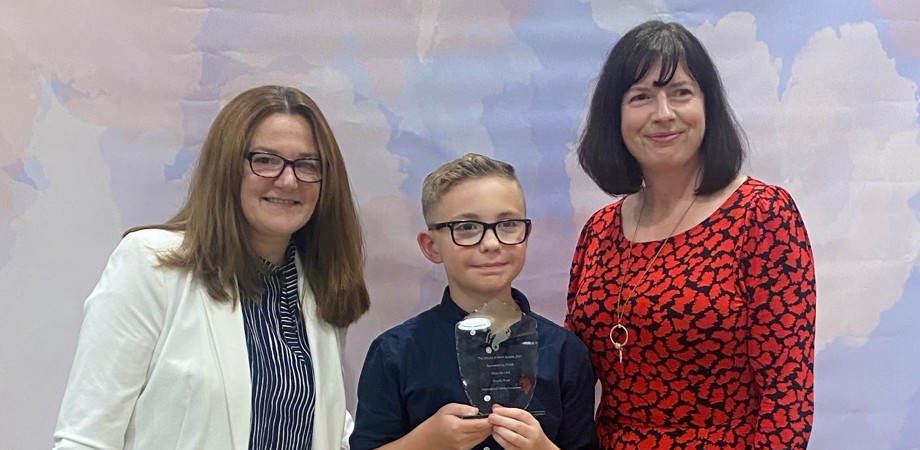 Barb Collister and Joanne Pontee posing with Charlie and his Heroes of Mann award