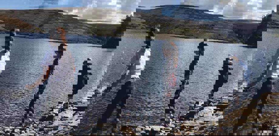 A picture of author of the article, Kathryn's children throwing stones into a reservoir