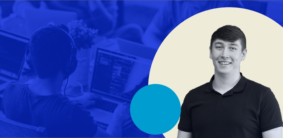 An image of Josh Corteen with a developer working in the background