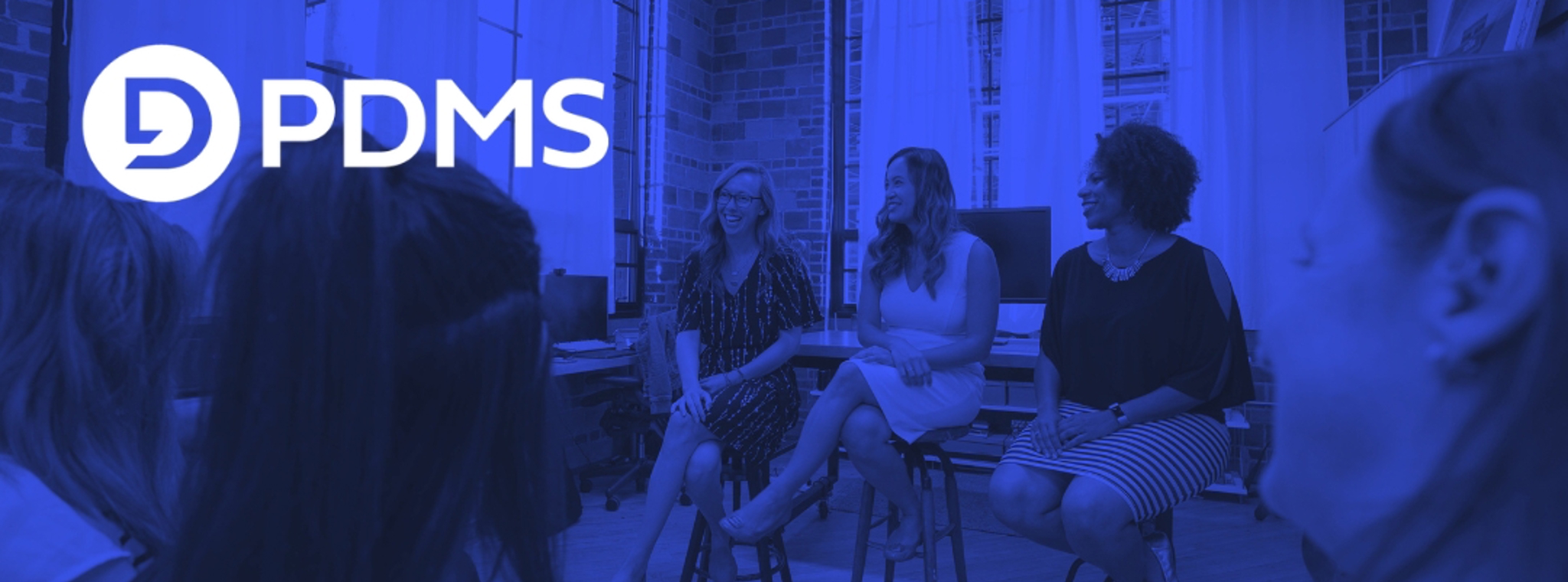 Photo of three women presenting to a room of female attendees with the PDMS logo overlaid