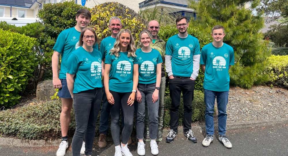 PDMS Race the Sun team outside PDMS building wearing their team shirts