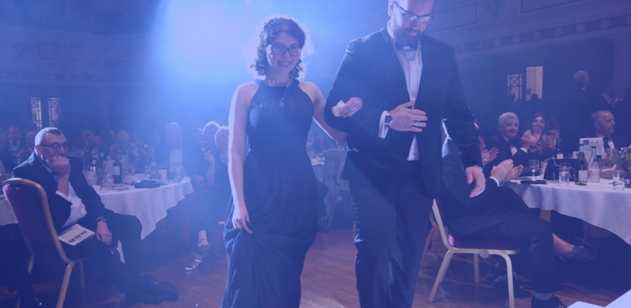 A photo of Alexandra walking on stage to collect her award