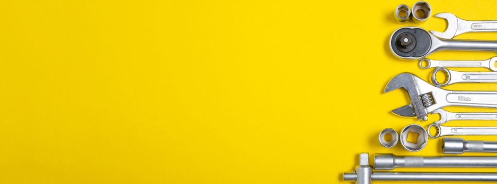 A variety of different tools on a yellow background