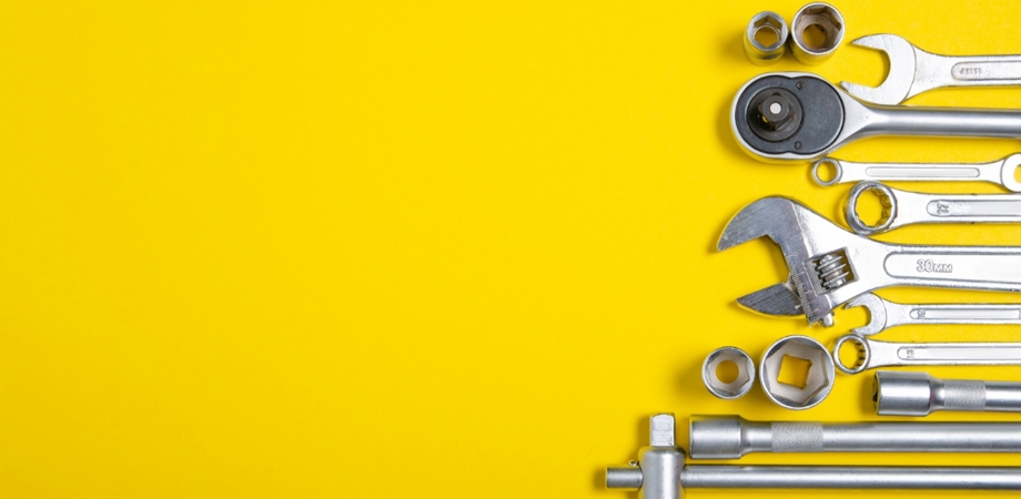 A variety of different tools on a yellow background