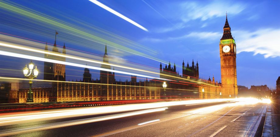 A photo of London Bridge in the evening with a timelapse of traffic passing by, indicating movement