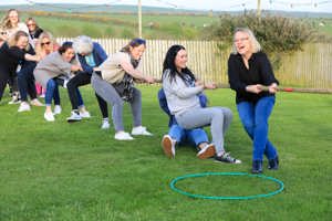 A group of women taking part in tug of war