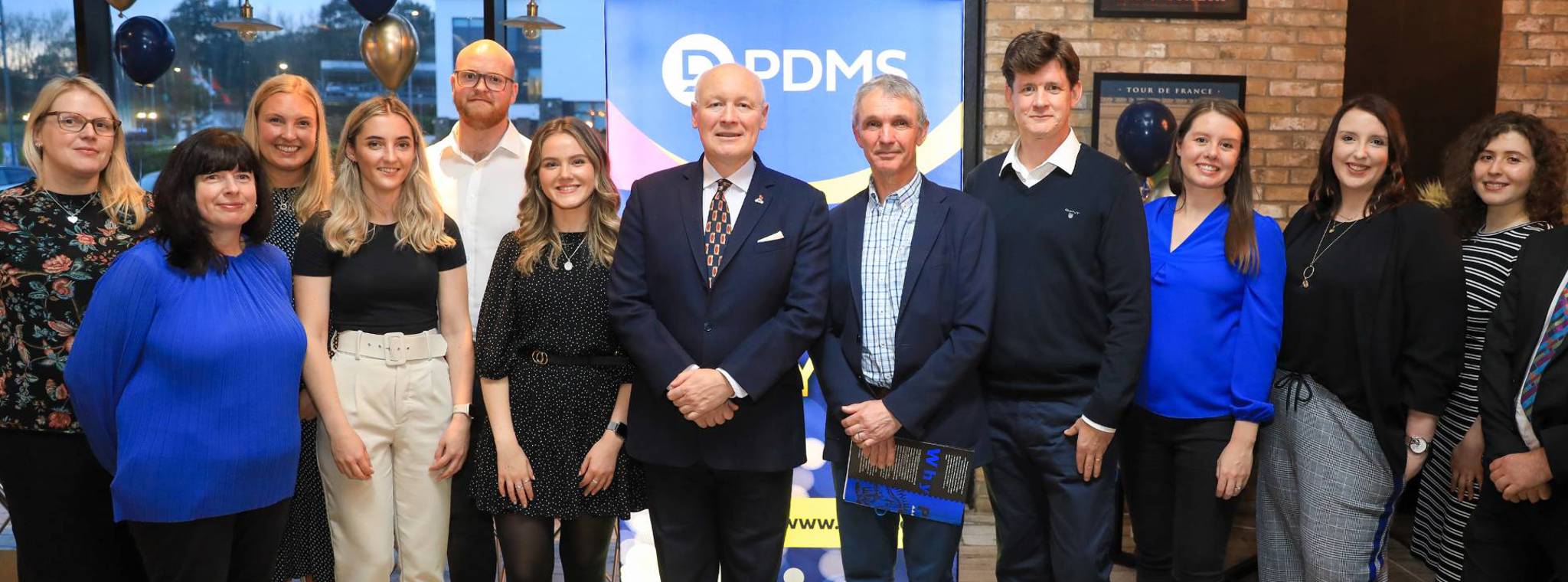 A group of PDMS staff posing for photo with the Lieutenant Governor General Sir John Lorimer