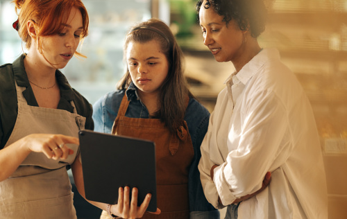 Supermarket staff looking at tablet