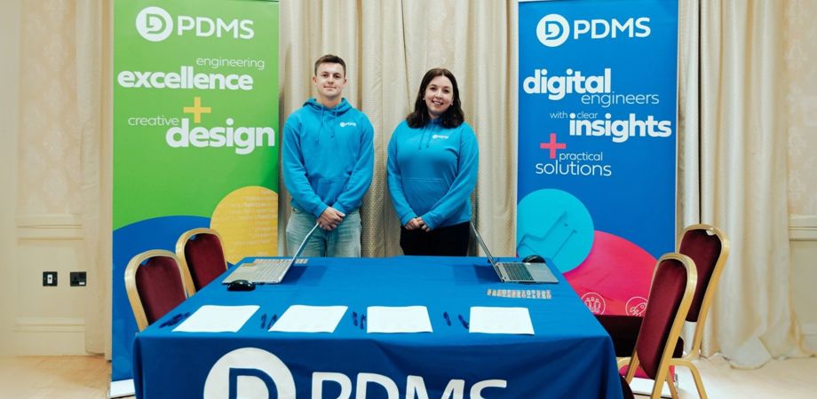 A photo of Rob and Hannah stood behind the PDMS stand at STEMFest