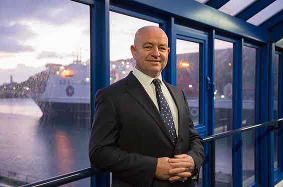 an image of duncan jude smiling at the camera with the ben my chree vessel visible in the background 