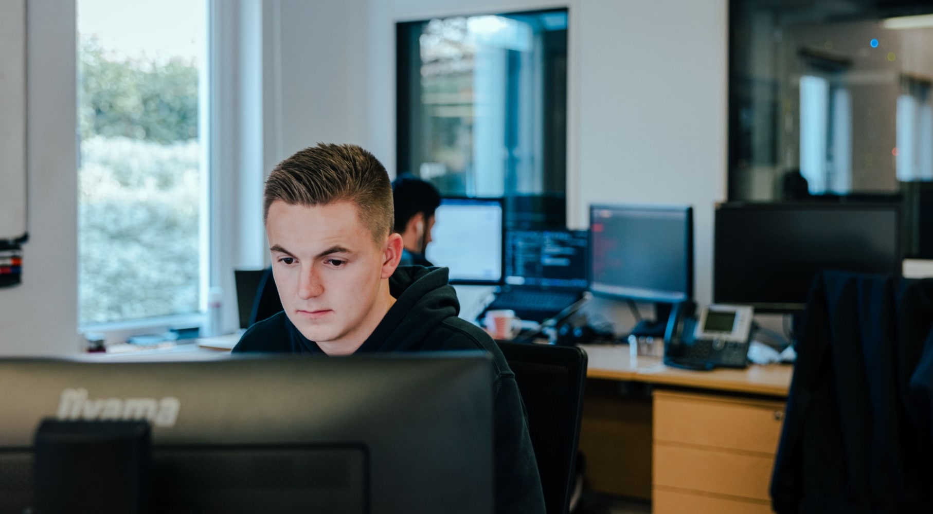 Infrastructure apprentice working at a computer