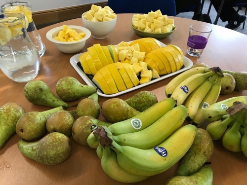 Bananas, pineapples, pears and lemons on a table