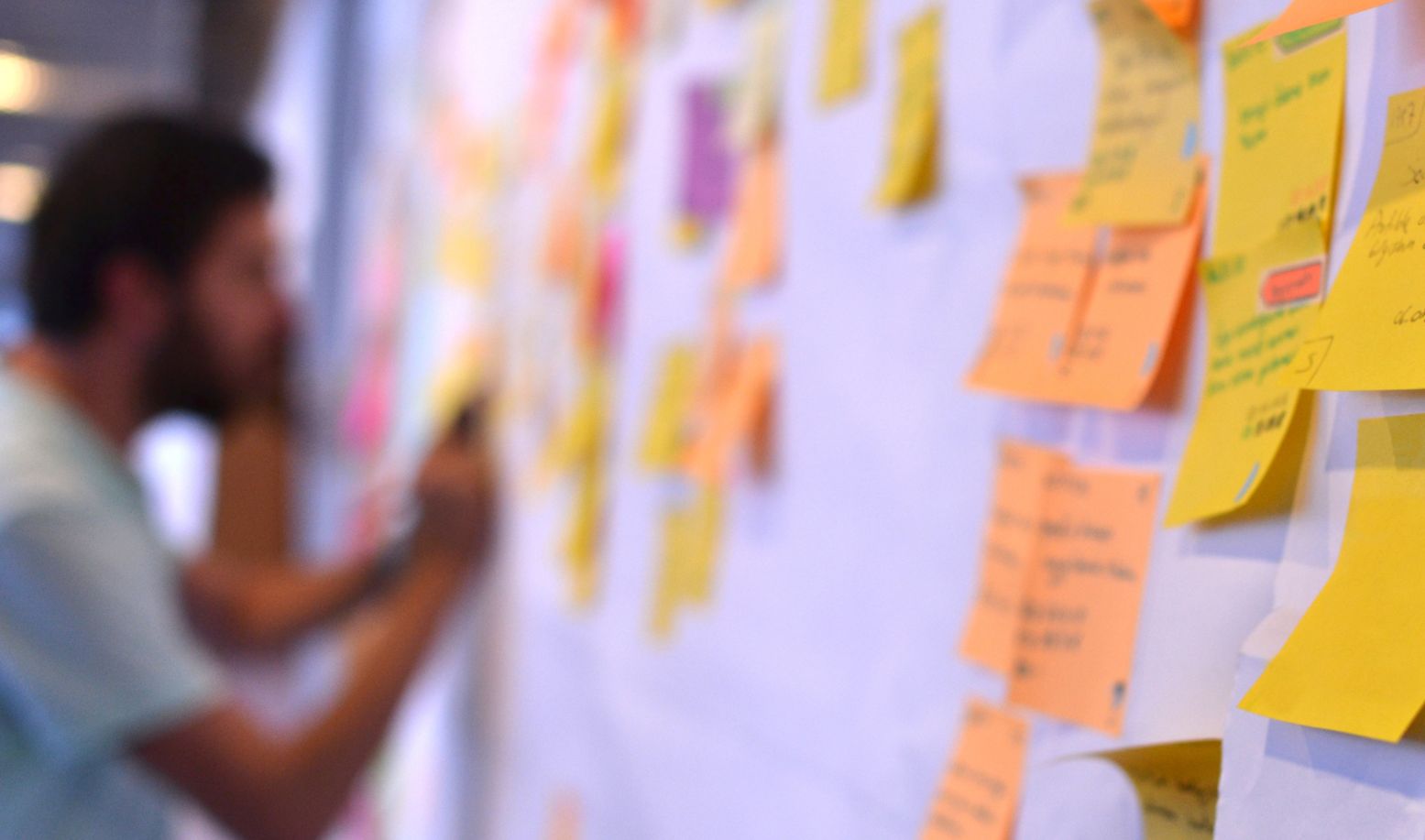  A photo of someone using a kanban board with Post-It notes to represent the Delivery Manager role