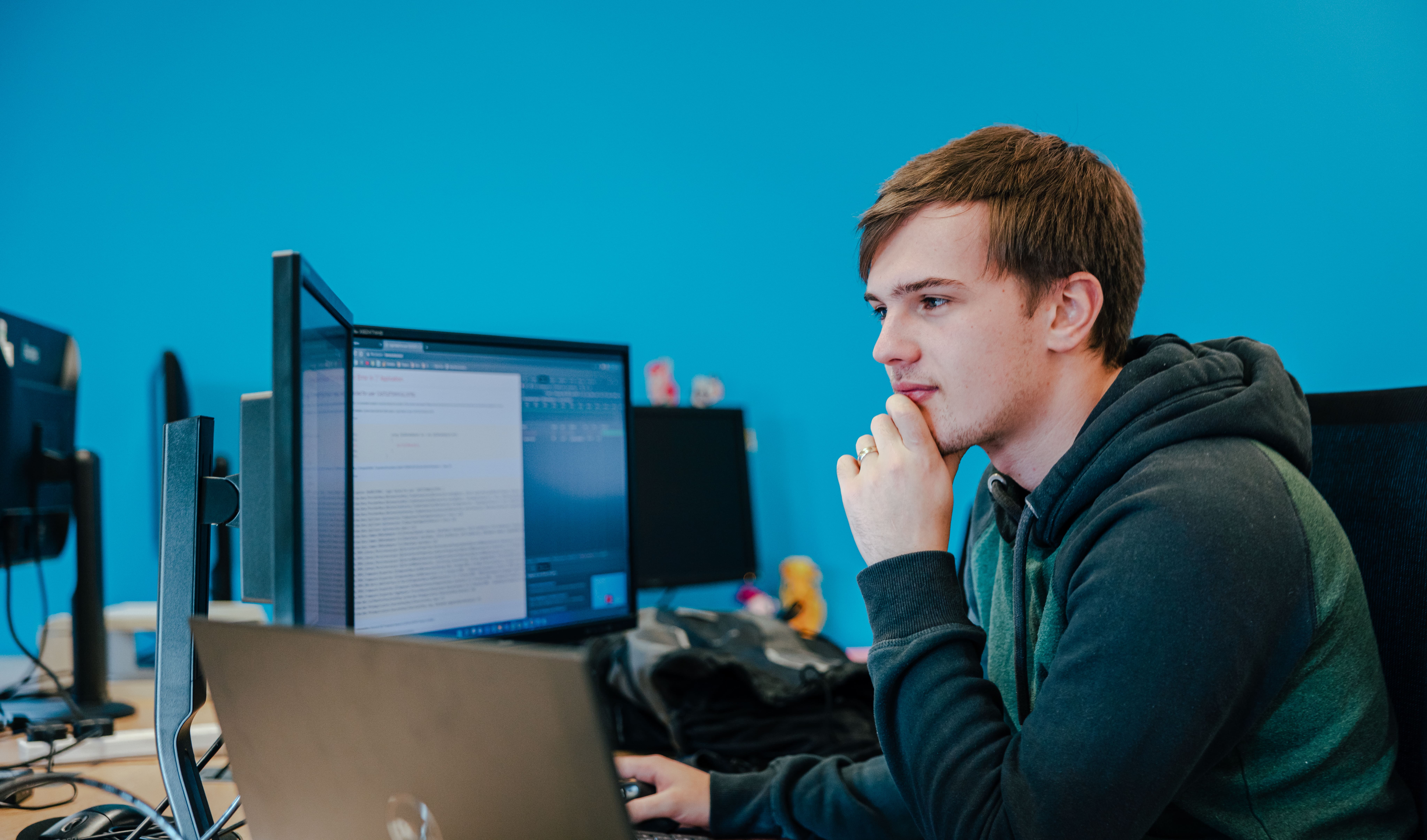 Developer at a desk with a computer screen with code