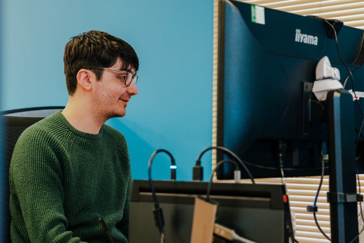Developer at a desk with a computer screen with code