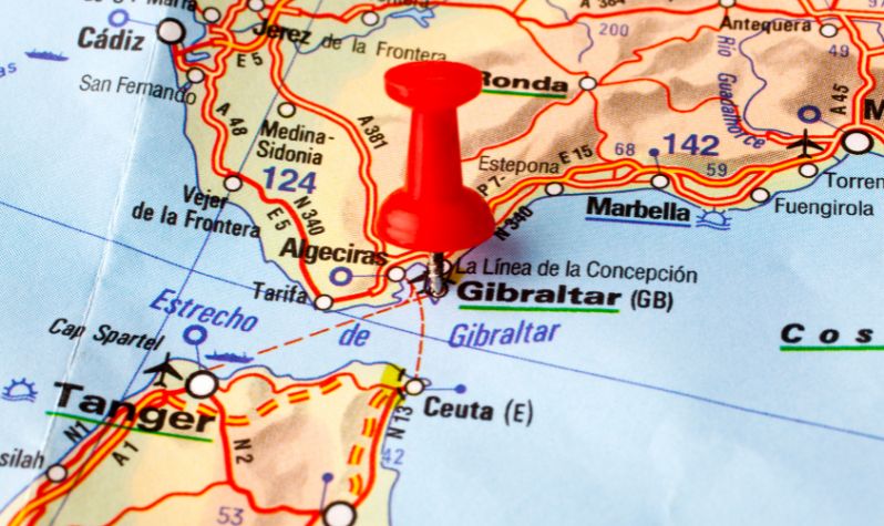 A photo of a map with Gibraltar marked by a pin