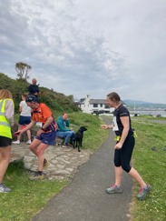 Steve Callaghan finishing his Race the Sun leg and preparing to hand the baton to Cat Watt