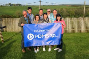 Board of Directors for PDMS posing with banner reading 'Celebrating PDMS 30 Years'