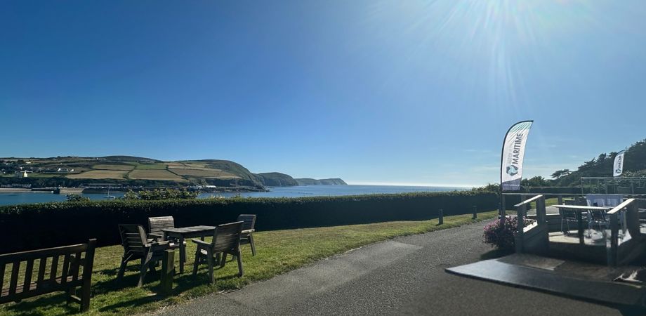 A panoramic photo of Port Erin bay from Bradda Glen with the Isle of Man Maritime flags in the foreground for the IOMM Powerhouse Event